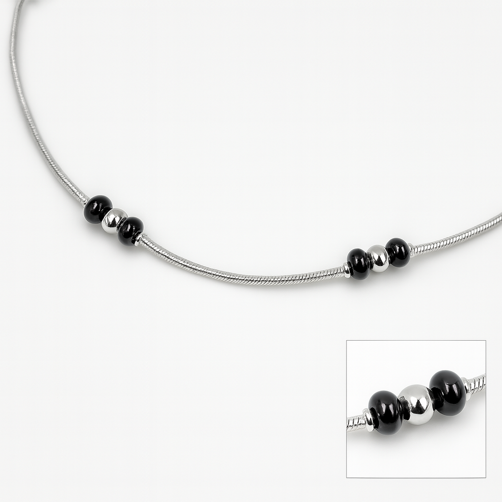 Silver anklet with black bead accents