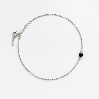 Silver anklet with single black bead