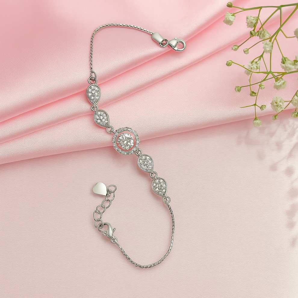 Silver bracelet with clear stones on a pink fabric background