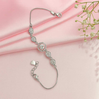 Silver bracelet with clear stones on a pink fabric background