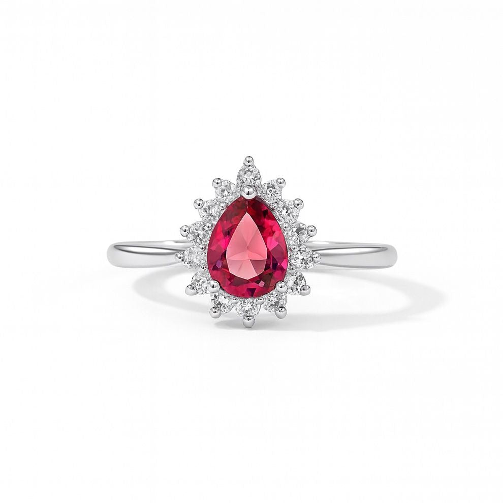 Silver ring with a pear-shaped pink gemstone and white background
