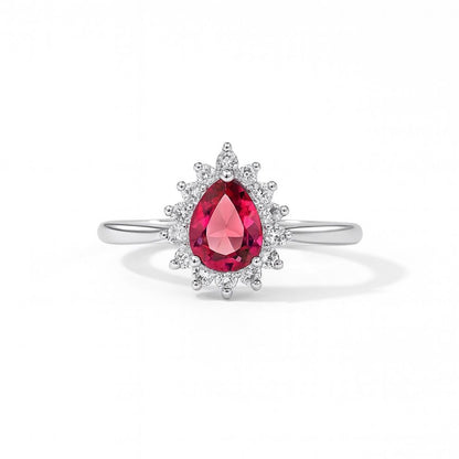 Silver ring with a pear-shaped pink gemstone and white background