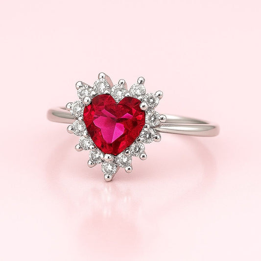 Silver ring for engagement with a heart-shaped pink gemstone on a light pink background, perfect for women