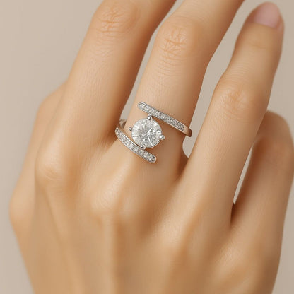 Silver ring with a large diamond look stone on a hand against a neutral background