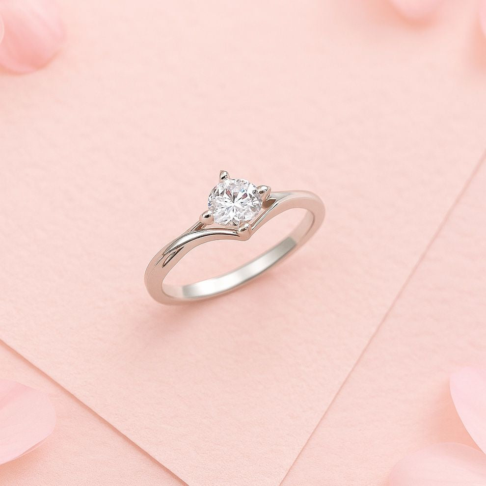 silver ring with on a pink fabric background