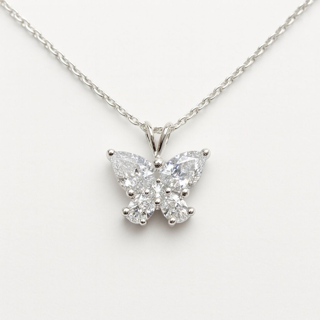 Butterfly-shaped diamond pendant on a chain against a white background