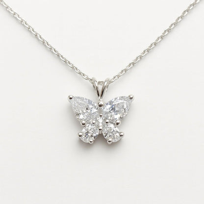 Butterfly-shaped diamond pendant on a chain against a white background