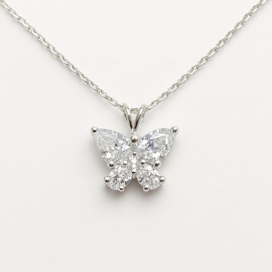 Butterfly-shaped diamond pendant on a chain against a white background