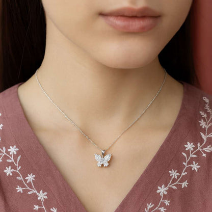 Butterfly necklace on a women wearing a pink embroidered top