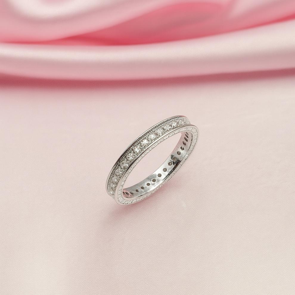 Silver ring on a pink satin background