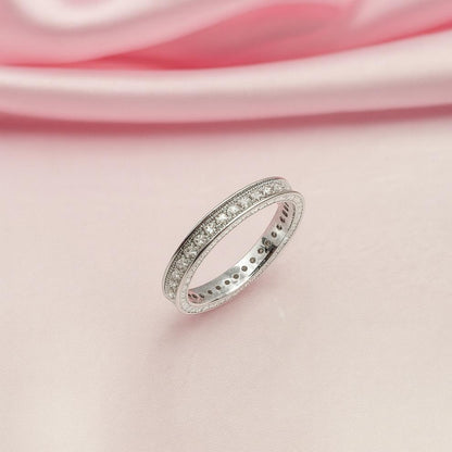 Silver ring on a pink satin background