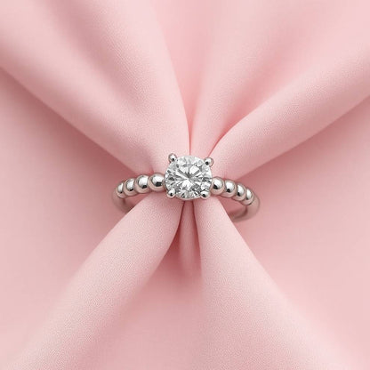 Silver ring with a diamond on pink fabric, perfect for college girl and office outfits