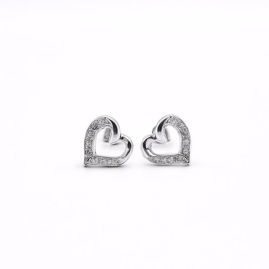 Heart-shaped earrings with small white stone on a white background