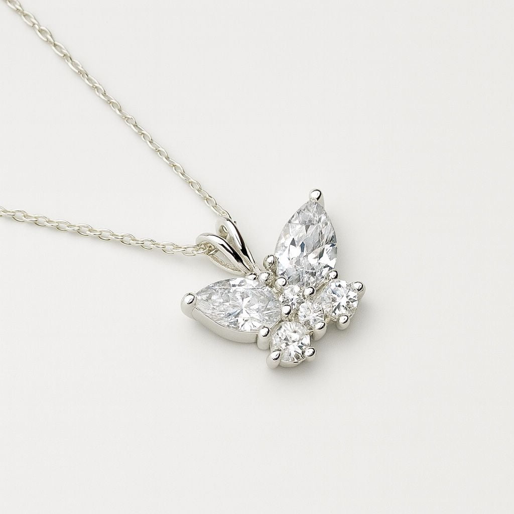Diamond butterfly pendant on a light grey background