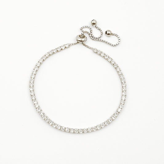 Silver tennis bracelet with clear stones on a white background