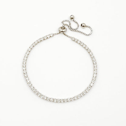 Silver tennis bracelet with clear stones on a white background