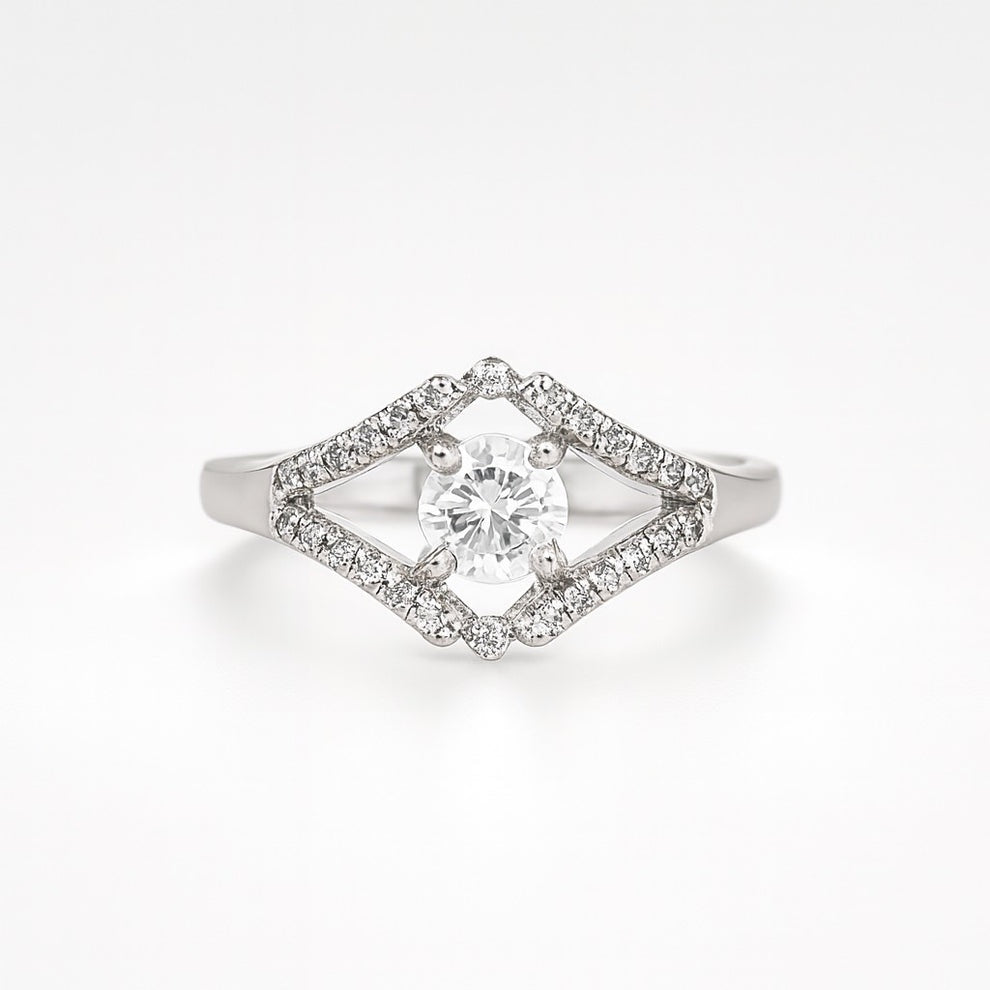 silver ring with a diamond-shaped halo on a white background