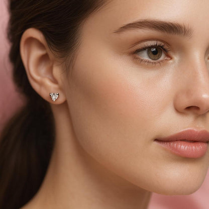 Close-up of a woman wearing a silver tiny earring for casual outfit with a soft pink background