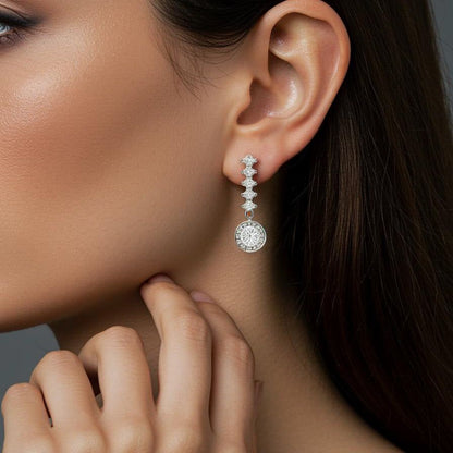 Close-up of a modern woman wearing elegant diamond earrings with a neutral background