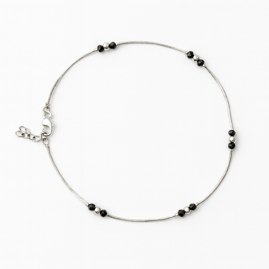 Silver anklet with black bead accents