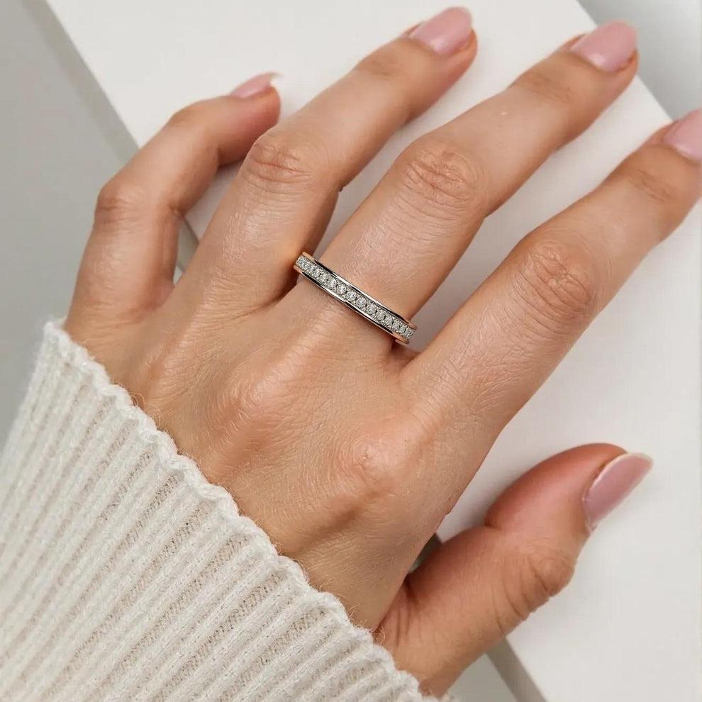 Hand wearing a silver ring with a white background, perfect for winter collection for girls
