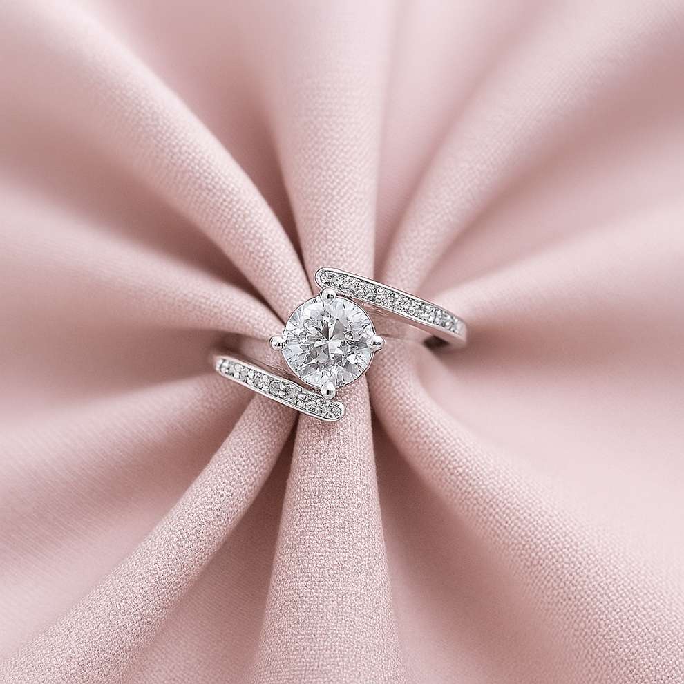 silver ring on a pink fabric background