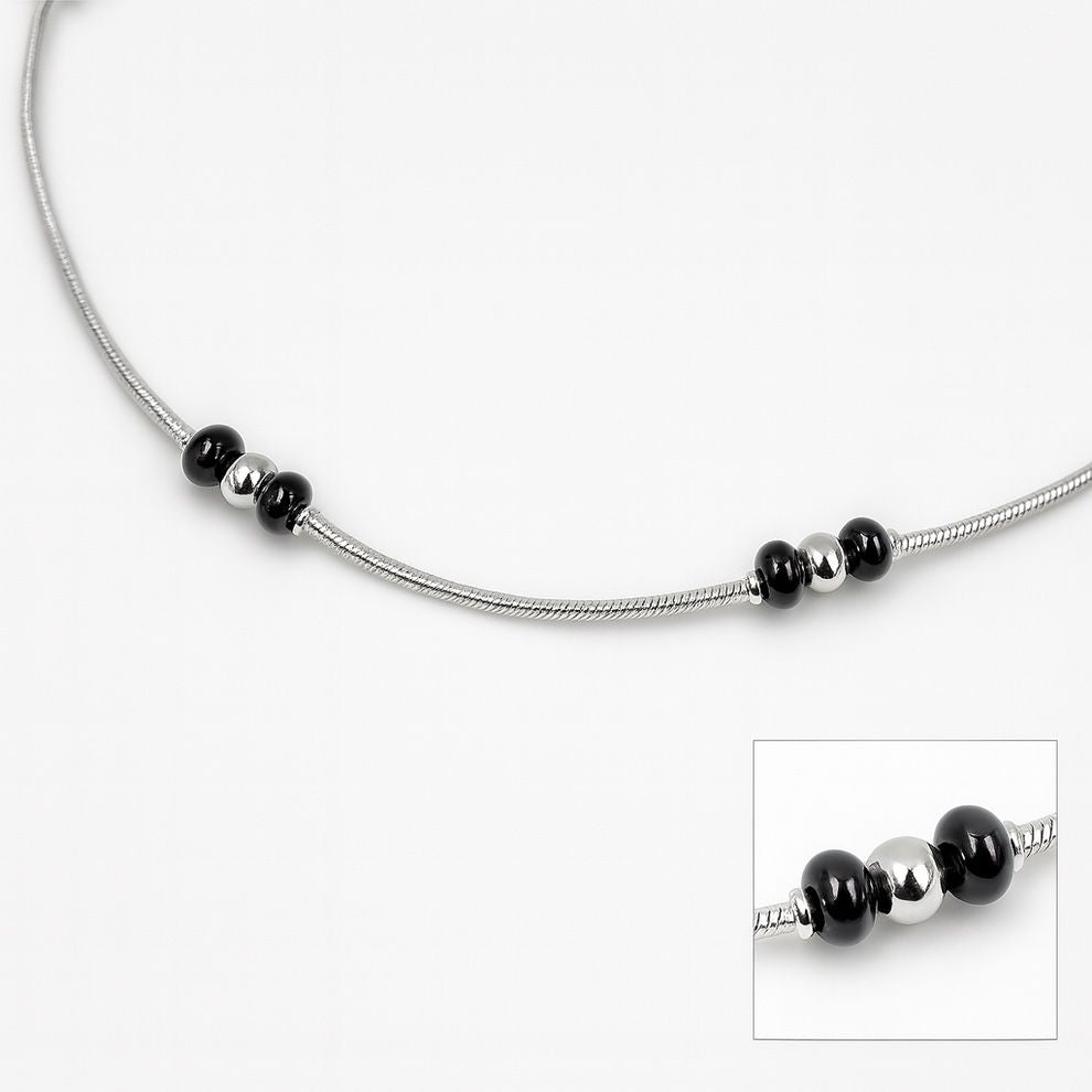 Silver anklet with black bead accents