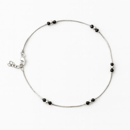 Silver anklet with black bead accents