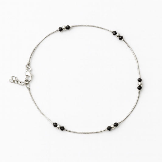 Silver anklet with black bead accents