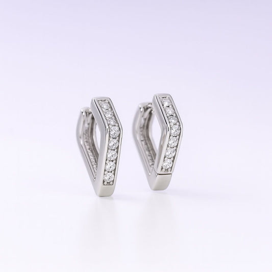 Pair of silver hoop earrings with embedded stones on a white background