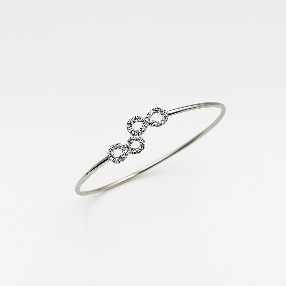 Silver bracelet with interlocking infinity rings on a white background