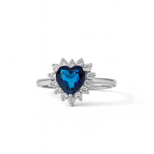 Silver ring with a heart-shaped blue gemstone on a white background