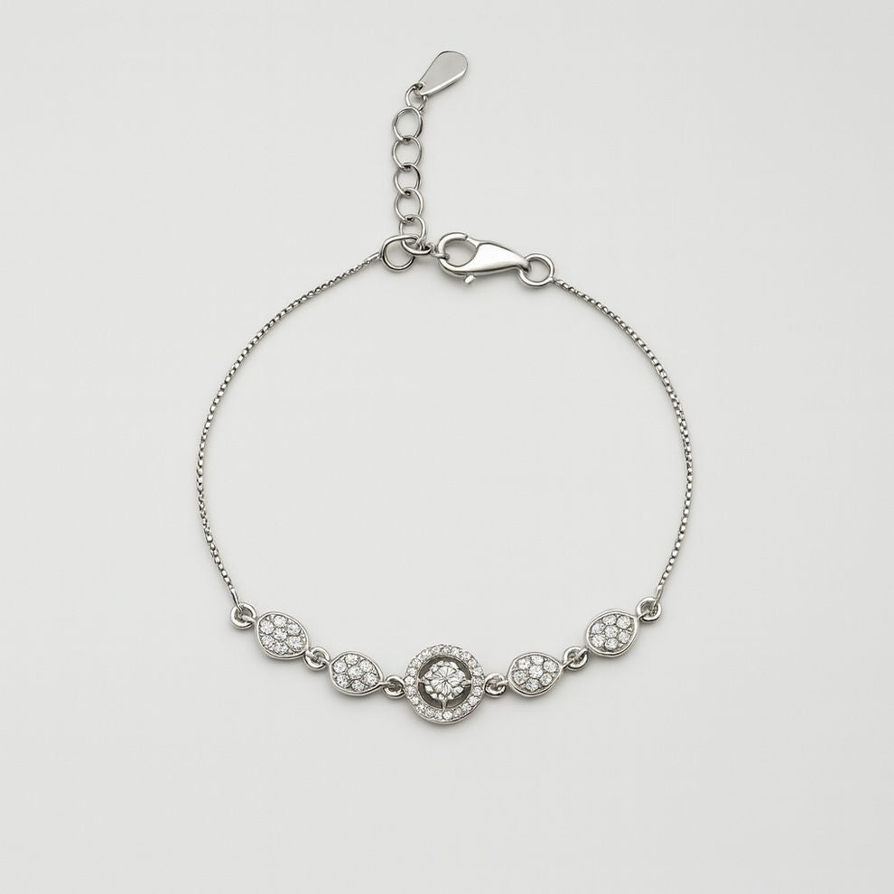 Silver bracelet with floral designs on a light gray background
