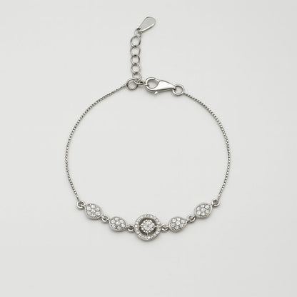 Silver bracelet with floral designs on a light gray background