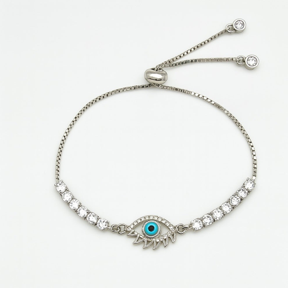 Silver bracelet with evil eye design and turquoise gemstone on a white background