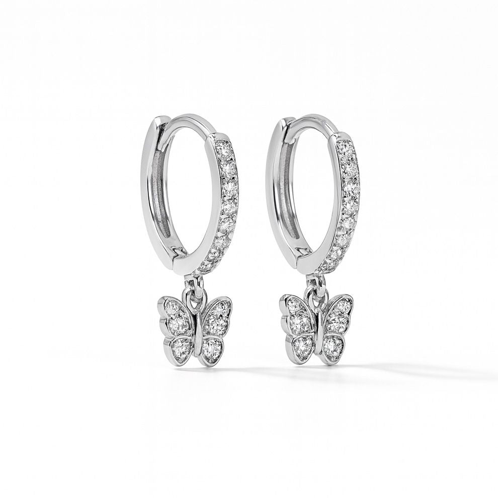 Silver hoop earrings with butterfly charms on a white background
