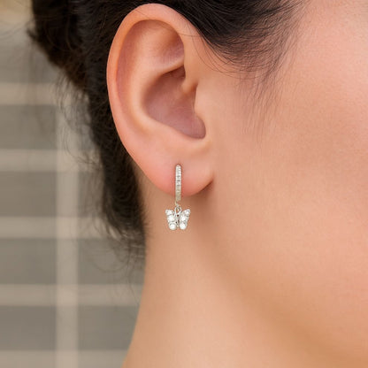Close-up of an ear wearing a silver butterfly earring, perfect for office and college girl, everyday wear