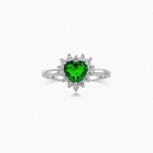 Silver ring with a heart-shaped green gemstone on a white background