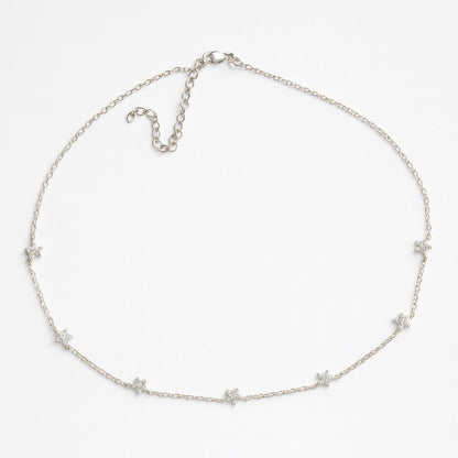 Silver necklace with star-shaped pendants on a white background