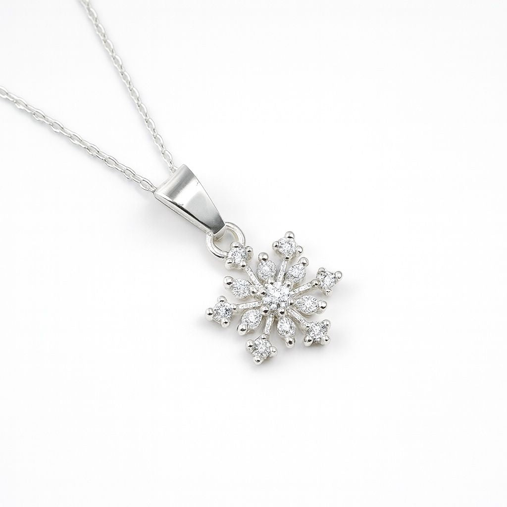 Silver snowflake pendant necklace on a white background