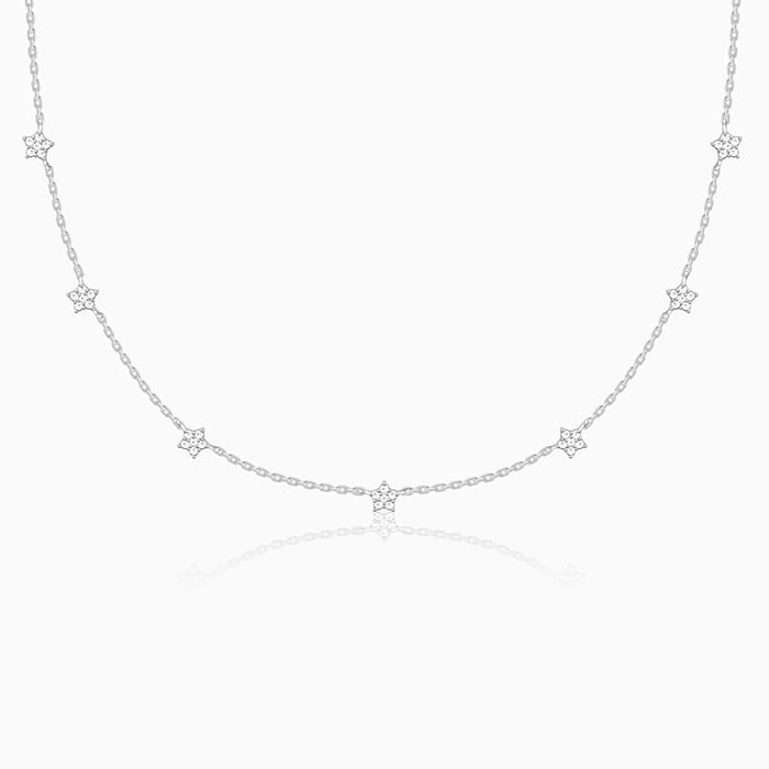 Delicate silver necklace with star-shaped pendants on a white background