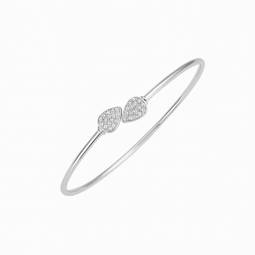 Silver bracelet with two leaf-shaped  accents on a white background
