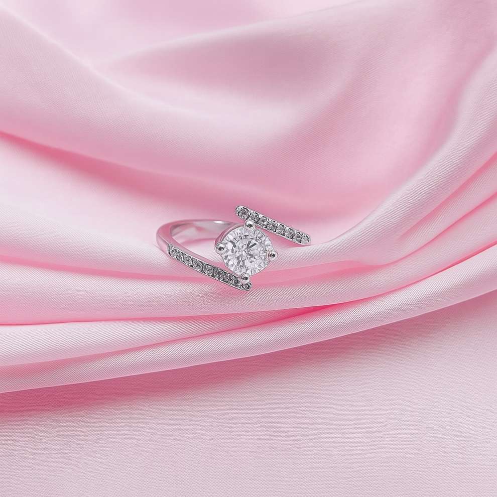 Silver ring with a diamond look on pink fabric
