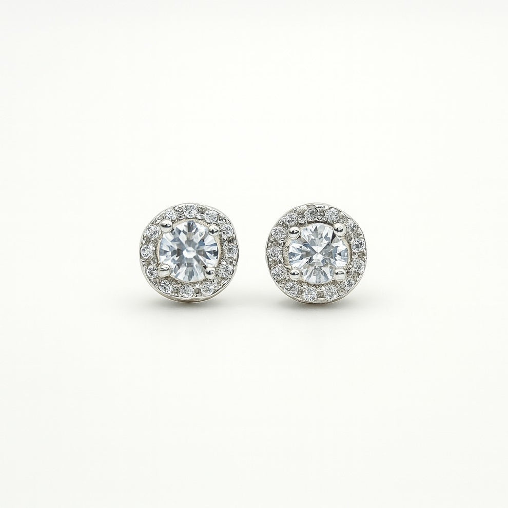 Pair of silver round stud earrings on a white background