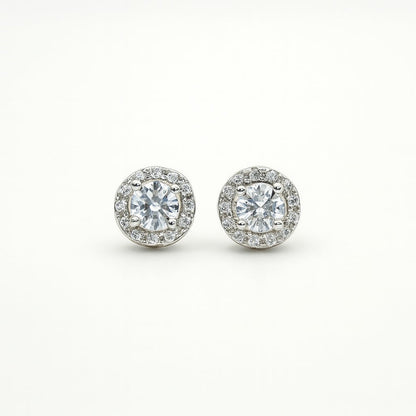 Pair of silver round stud earrings on a white background