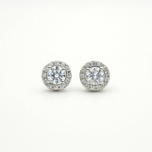 Pair of silver round stud earrings on a white background