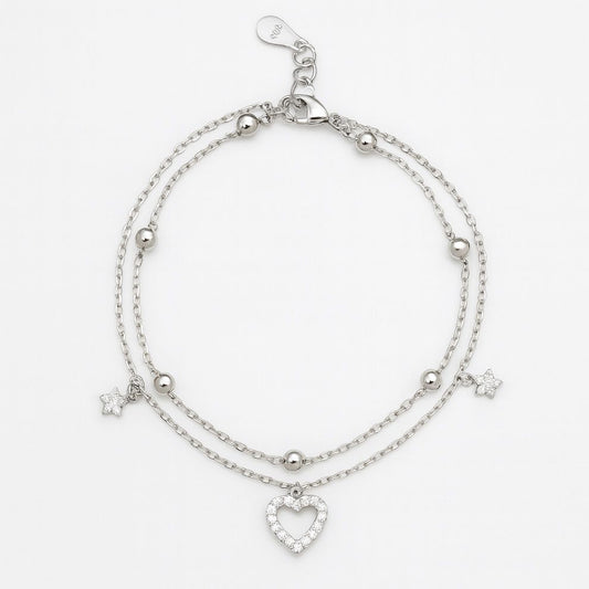 Silver bracelet with heart charm and star accents on a white background