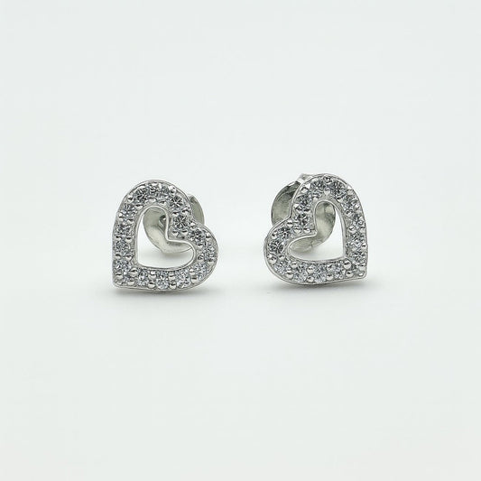 Heart-shaped silver earrings with clear stones on a white background