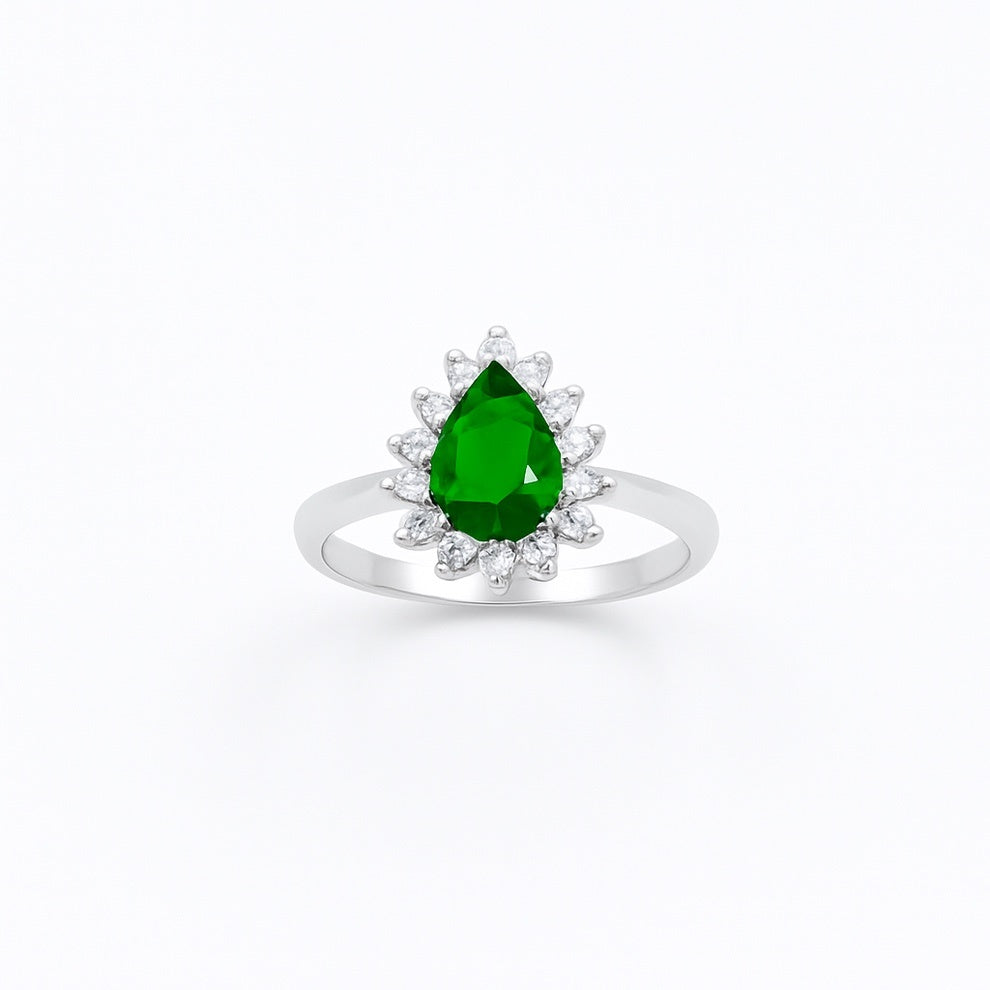 silver ring with a green gemstone on a white background