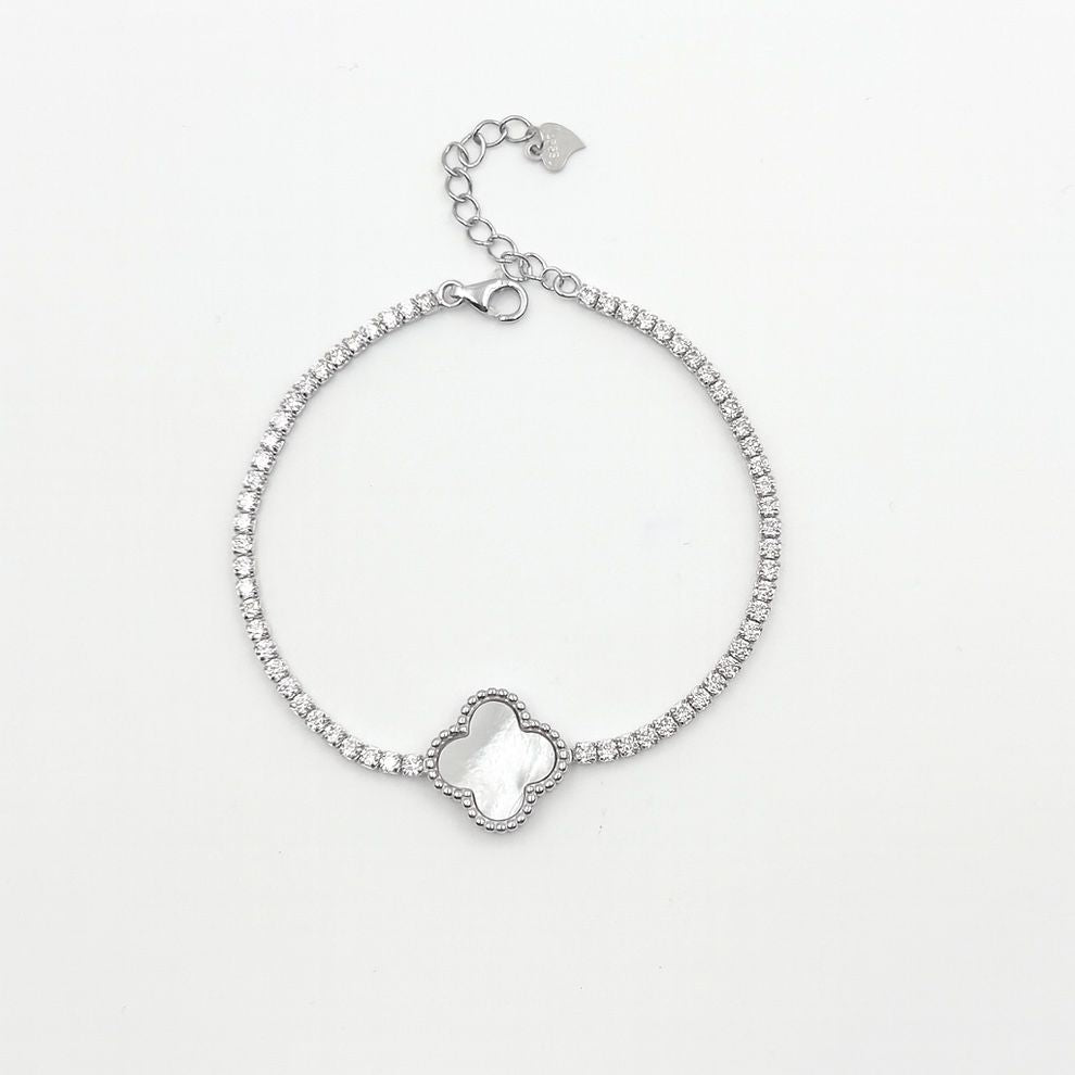 Silver bracelet with a floral-shaped clasp on a light grey background